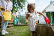 © AD Astra Team/Stocksy - Mom and daughter watering the garden