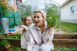 © AD Astra Team/Stocksy - Mom and daughter are picking cabbage in the garden