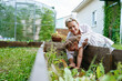 © AD Astra Team/Stocksy - Mom and daughter plant seeds in the garden