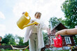 © AD Astra Team/Stocksy - Mom and daughter watering the garden