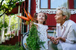 © AD Astra Team/Stocksy - Mom and daughter hold a bunch of carrots near a country house