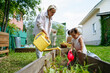 © AD Astra Team/Stocksy - Mom and daughter watering the garden
