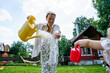 © AD Astra Team/Stocksy - Mom and daughter watering the garden