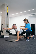 Man Doing Rehabilitation Exercises With His Physical Therapist