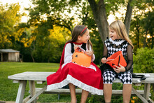 Halloween Friends Discussing Trick Or Treat Candy