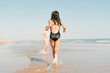 © Eloisa Ramos/Stocksy - Girl running by the beach