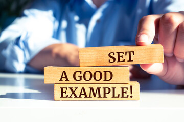 wooden blocks with words 'set a good example'.