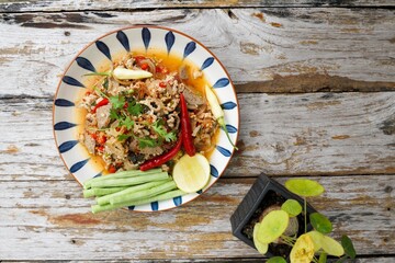 Spicy minced pork salad served with fresh vegetables  Minced pork salad is a popular traditional Thai food of Thailand.  Spicy Minced Pork Salad is also called Larb Moo.