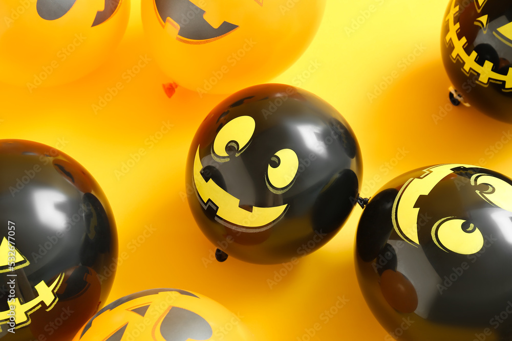 Funny Halloween balloons on yellow background