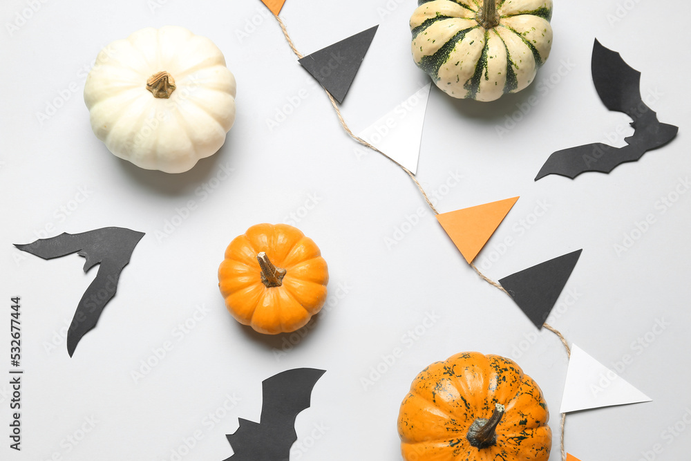 Composition with pumpkins and Halloween decor on white background