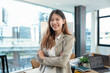 Portrait of successful business asian woman with arms crossed and smile , Young businesswoman smiling and looking at camera in meeting room, Happy feeling concept