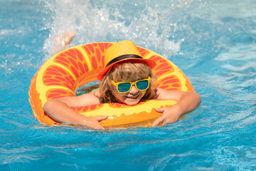 Wall Mural - Kid boy relaxing in pool. Child swimming in water pool. Summer kids activity, watersports. Summer vacation with children.