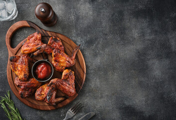 Wall Mural - Grilled chicken wings with ketchup. Spicy chicken wings. Top view. Copy space