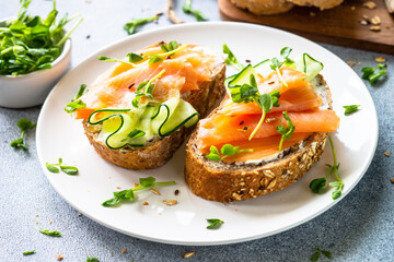 Sticker - Open sandwich with cream cheese, salmon and cucumber. Healthy breakfast or snack. close up.