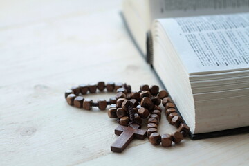 praying with the bible and cross on a table at home 