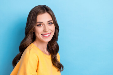 Poster - Photo portrait of stunning young woman toothy smile shopping promo banner wear trendy yellow garment isolated on blue color background