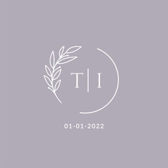 Initial monogram TI wedding logo with decorative floral frame