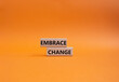 © Natallia - Embrace change symbol. Concept word Embrace change on wooden blocks. Beautiful orange background. Business and Embrace change concept. Copy space