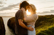 © ADDICTIVE STOCK - Couple hugging against sundown sky