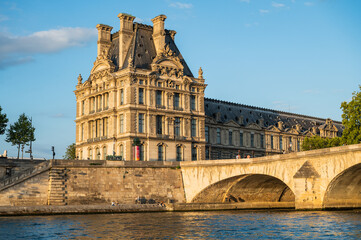 Wall Mural - Pont Royal, five-arch bridge over river Seine in Paris, the third oldest bridge in Paris. View from the boat, evening light