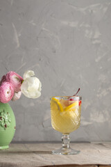 Wall Mural - glass of white wine sangria cocktail decorated with citrus slices on the table