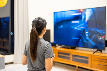 Poster - Woman play video TV game at home