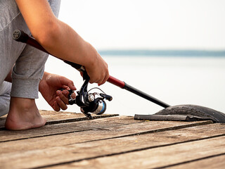 Wall Mural - The process of fishing. Favorite occupation, recreation, hobby. Without a face.