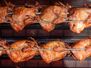 Wall Mural - Really crispy chicken at the Oktoberfest 2022 rotary grill in Munich