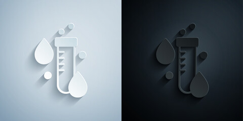 Paper cut Test tube with water drop icon isolated on grey and black background. Paper art style. Vector