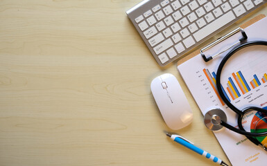 Doctor's desk with a laptop computer, medical analysis graph documents, and supplies Flat lay, top view with copy space