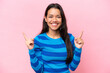 Young Colombian woman isolated on pink background pointing up a great idea