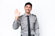 Young safeguard man over isolated white background saluting with hand with happy expression
