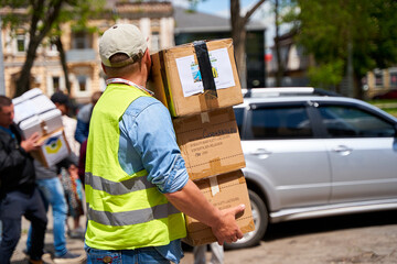 Ukrainian volunteers unloading boxes with humanitarian aid