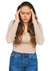 Wall Mural - Young hispanic girl wearing casual clothes with hand on head for pain in head because stress. suffering migraine.