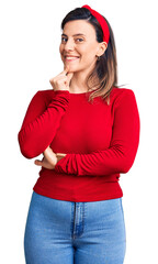 Wall Mural - Young beautiful woman wearing casual clothes looking confident at the camera with smile with crossed arms and hand raised on chin. thinking positive.