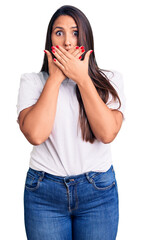 Wall Mural - Young beautiful brunette woman wearing casual t-shirt shocked covering mouth with hands for mistake. secret concept.