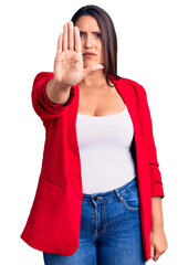 Canvas Print - Young beautiful brunette woman wearing elegant clothes doing stop sing with palm of the hand. warning expression with negative and serious gesture on the face.