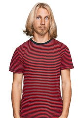 Sticker - Caucasian man with blond long hair wearing casual striped t shirt depressed and worry for distress, crying angry and afraid. sad expression.