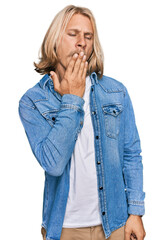 Poster - Caucasian man with blond long hair wearing casual denim jacket bored yawning tired covering mouth with hand. restless and sleepiness.