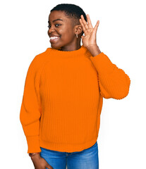 Poster - Young african american woman wearing casual clothes smiling with hand over ear listening an hearing to rumor or gossip. deafness concept.