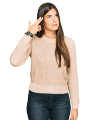 Canvas Print - Young brunette woman wearing casual winter sweater shooting and killing oneself pointing hand and fingers to head like gun, suicide gesture.