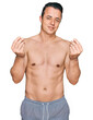© Krakenimages.com - Handsome young man wearing swimwear shirtless doing money gesture with hands, asking for salary payment, millionaire business