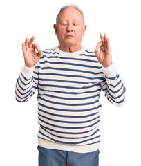 Canvas Print - Senior handsome grey-haired man wearing casual striped sweater relax and smiling with eyes closed doing meditation gesture with fingers. yoga concept.