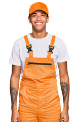 Sticker - Young handsome african american man wearing handyman uniform with a happy and cool smile on face. lucky person.