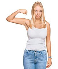 Sticker - Young blonde girl wearing casual style with sleeveless shirt strong person showing arm muscle, confident and proud of power