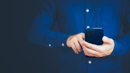 Businessman texting on mobile phone in his office. Communication, work or meeting, connection, mobile apps, technology. Young man using smartphone at home. Lifestyle working concept.
