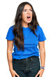 © Krakenimages.com - Beautiful brunette young woman wearing casual clothes angry and mad screaming frustrated and furious, shouting with anger. rage and aggressive concept.