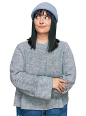 Canvas Print - Young hispanic woman wearing cute wool cap smiling looking to the side and staring away thinking.