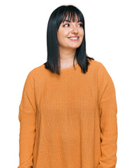 Poster - Young hispanic woman wearing casual clothes looking away to side with smile on face, natural expression. laughing confident.