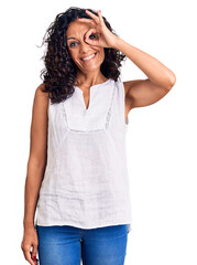 Wall Mural - Middle age beautiful woman wearing casual sleeveless t shirt smiling happy doing ok sign with hand on eye looking through fingers